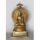 Gilt cast metal Buddha vista figure, probably Shiva upon a stepped square base, 21cm high