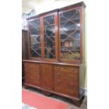 A 19th century mahogany library bookcase, the lower section fitted with eight frieze drawers and