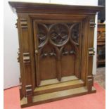 A Victorian oak cabinet with Gothic tracery detail, enclosed by a single door with further applied