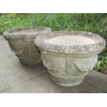 A pair of reclaimed garden planters of circular tapered form with fruiting swag detail (af), 50 cm