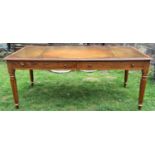 A late 19th century oak library or writing table of rectangular form with inset leather top,