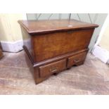 A Georgian oak coffer bach, with rising lid over two small frieze drawers, raised on a shaped