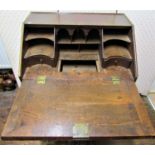 A small 18th century oak writing bureau with three long and two short graduated drawers, the fall