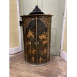 A Georgian oak bow fronted hanging corner cupboard with chinoiserie detail, characters, pagodas