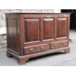 A small Georgian pine mule chest with rising lid, the front elevation enclosed by three panels