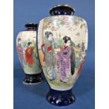 A matched pair of early 20th century oriental vases in the Satsuma manner with painted panels of