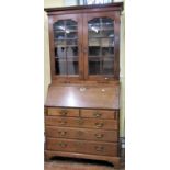 A Georgian mahogany bureau bookcase of three long and two short drawers, the fall flap with fitted