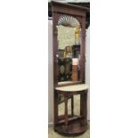 A Victorian style mahogany hall stand with raised mirror back, simulated marbled surface and