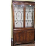 A good quality reproduction side cabinet of full height, the lower section enclosed by a pair of