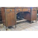 A William IV period inverted breakfront pedestal sideboard, with reeded column supports, enclosing