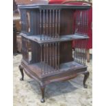 An Edwardian mahogany revolving bookcase on two tiers, the platform base with pad feet (af) 60cm