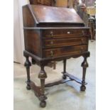 Small William and Mary style ladies writing bureau in walnut, the fall flap enclosing a simply