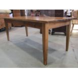 A good quality traditional farmhouse table in reclaimed timbers, the planked top raised on four