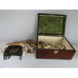 A walnut casket containing a collection of interesting items to include silver plated flatware, a