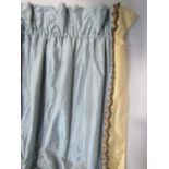 One pair of full length curtains in steel blue dupion silk with a contrasting brown silk band on