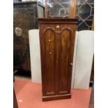 An unusual 19th century mahogany cupboard enclosed by a single door, the front and sides applied