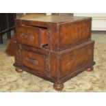 A contemporary two tier occasional table presented as two graduated suitcases, with mock leather