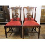 A set of five Georgian mahogany dining chairs with carved and pierced splats and yoke shaped