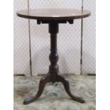 A simple mahogany occasional table, the circular top 53cm diameter, raised on a turned pillar and