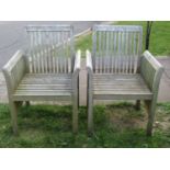 A pair of Made On Earth weathered teak garden armchairs with slatted framework