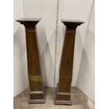 A pair of mahogany torchere with reeded and tapering columns, 112cm high (2)