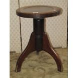 An Edwardian office or industrial stool, the circular dished top with rising mechanism and tripod
