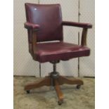 A vintage office chair with upholstered framework on a swivel base
