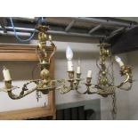 A pair of good quality cast gilt metal five branch hanging ceiling lights with scrolling acanthus