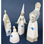 Three Lladro figures comprising a girl holding a lamb, a fairy godmother with wand, a group of the