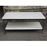 A contemporary two tier occasional table, with painted finish raised on ironwork supports, 110cm x