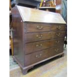 A substantial mahogany bureau of four long and two short drawers, set on bracket supports, the