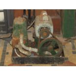 A small vintage Lister engine/pump with electric motor and belt driven fly wheel, number to block