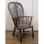 A Georgian comb back elbow chair, principally in elm and ashwood, with turned supports and crinoline