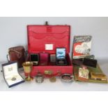 A vintage Morocco leather briefcase containing a collection of interesting items comprising an