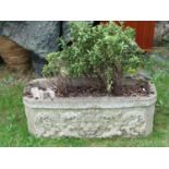 A reclaimed garden planter of rectangular form with canted corners and raised lions mask scrolling