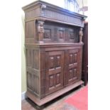 A substantial 18th century German oak court cupboard, the lower section enclosed by two quarter