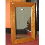 Contemporary wall mirror of rectangular form with a simple wedge shaped oak frame 90 cm x 60 cm