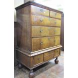 A Georgian walnut chest on stand, the chest of three long and two short drawers, cross banded, the