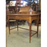 A late 19th century pale mahogany ladies writing desk, raised on four square tapered supports,