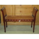 A Bright's of Nettlebed 064631 mahogany window or duet stool in the Regency style with cane panelled