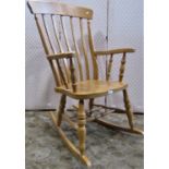 A contemporary beech wood Windsor lathe back rocking chair of traditional design