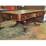 A Regency rosewood veneered library or writing table, the rectangular top inset with leather,