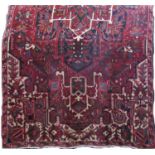 A good quality unusual Persian rug with elaborate central floral layered medallion upon a red