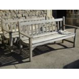 A pair of RA Lister weathered teak three seat garden benches with slatted seats and backs, length: