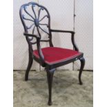 An Edwardian mahogany open elbow chair, the shield shaped back with shaped splat over upholstered