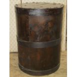 A vintage wooden cylindrical bin with staved bands and partially hinged lid