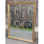 A contemporary wall mirror of rectangular form with bevelled edge plate within a moulded gilt