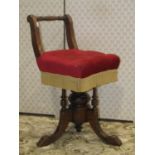 A Victorian musicians chair with upholstered seat, with adjustable height, the central column set