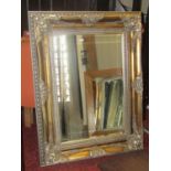 Contemporary, antique-style wall mirror of rectangular form with bevelled edge plate within a