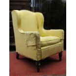 Mid-19th century upholstered wing armchair on turned forelegs with recent reupholstered yellow